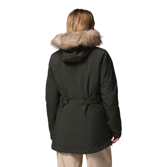 Person wearing a black parka with fur hood on a white background