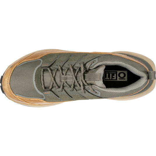 Green and brown sneaker with 'On' logo on a white background