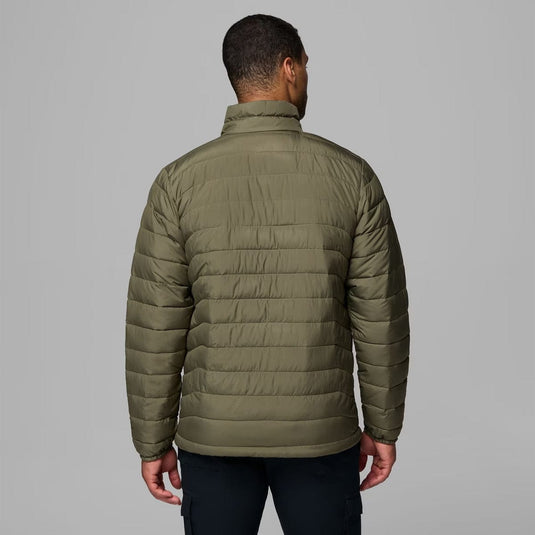 Person wearing a green puffer jacket on a gray background