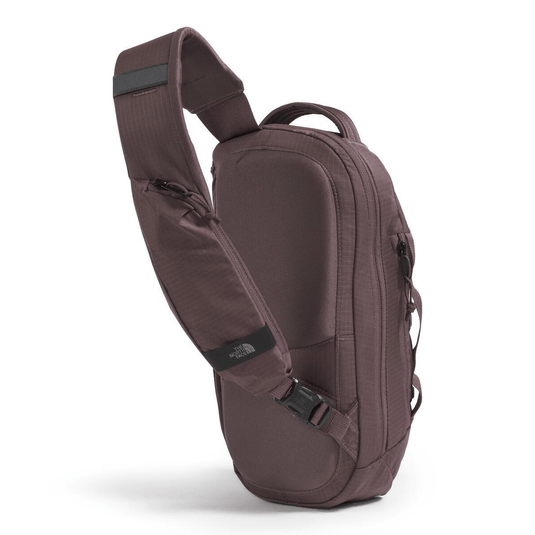 Brown sling bag with visible branding on a white background