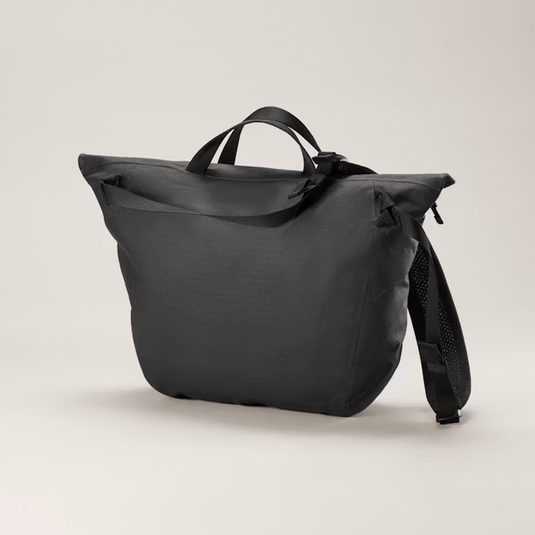 Black backpack on a light beige background