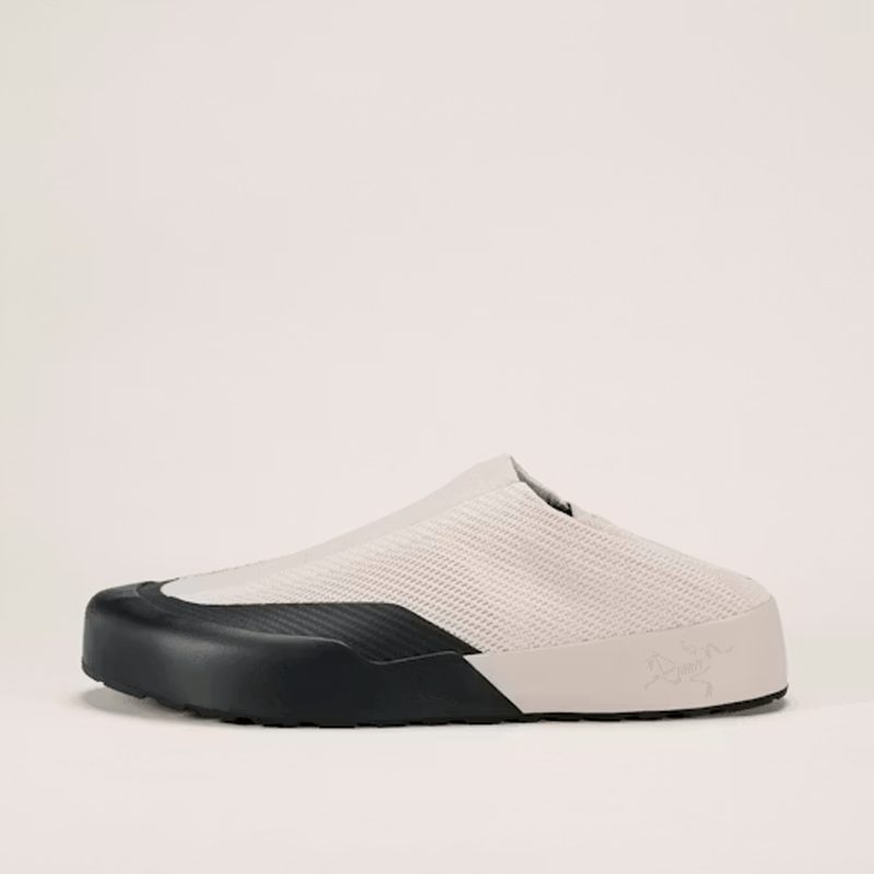 Load image into Gallery viewer, White slip-on shoe with black sole on a light beige background
