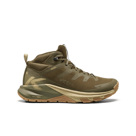 Green hiking boot with brown sole on a white background