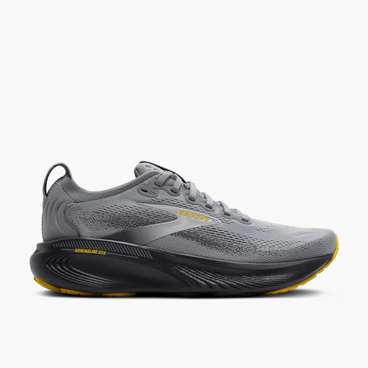 Gray running shoe with yellow accents on a white background