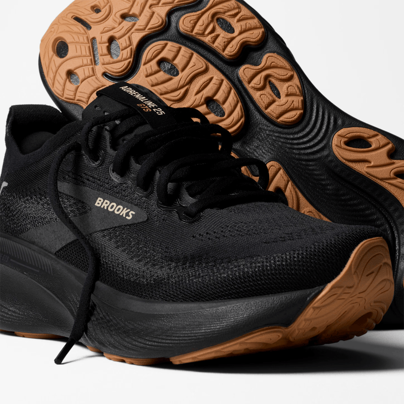Load image into Gallery viewer, Black running shoe with brown sole on a white background
