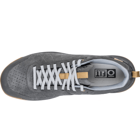 Gray sneaker with white laces on a white background