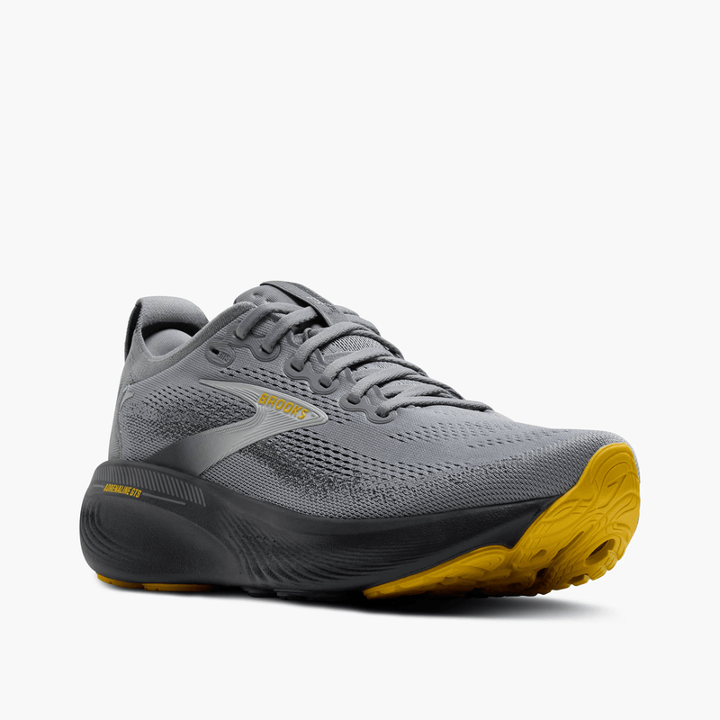 Load image into Gallery viewer, Gray running shoe with yellow sole on a white background
