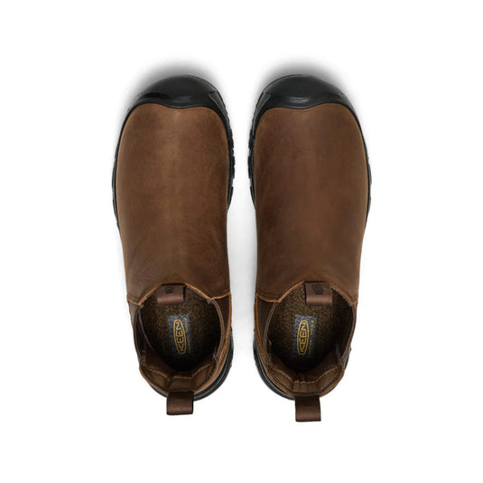 Pair of brown ankle boots with black soles on a white background