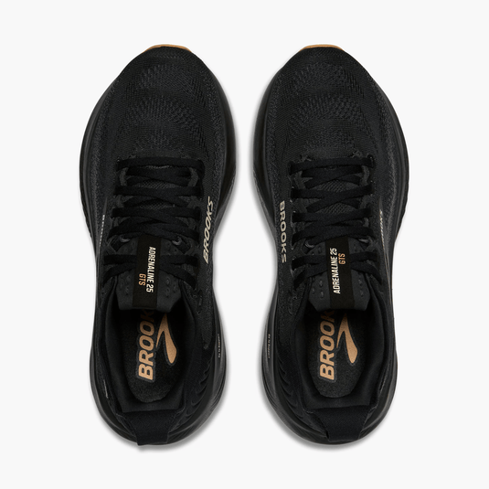 Black running shoes with gold accents on a white background
