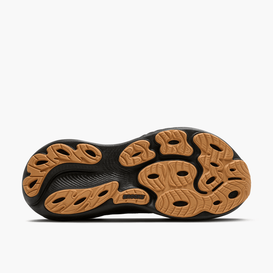 Close-up of a shoe sole with black and brown design on a white background